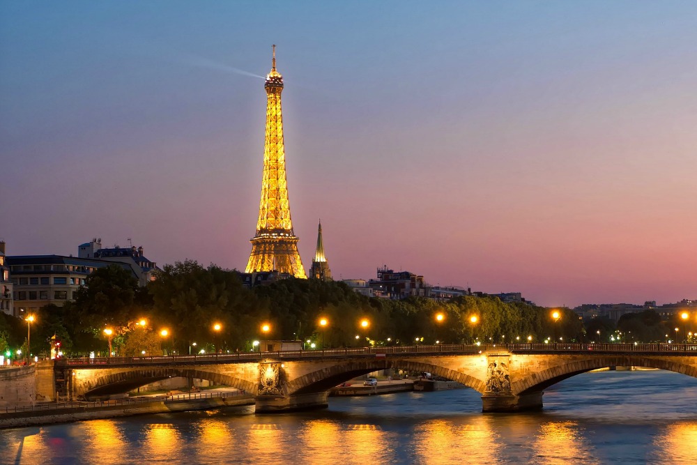 Eiffel Tower at night with Seine River lit up